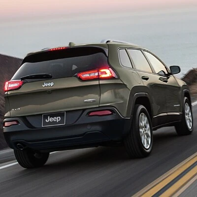 A new Jeep Cherokee driving on a road